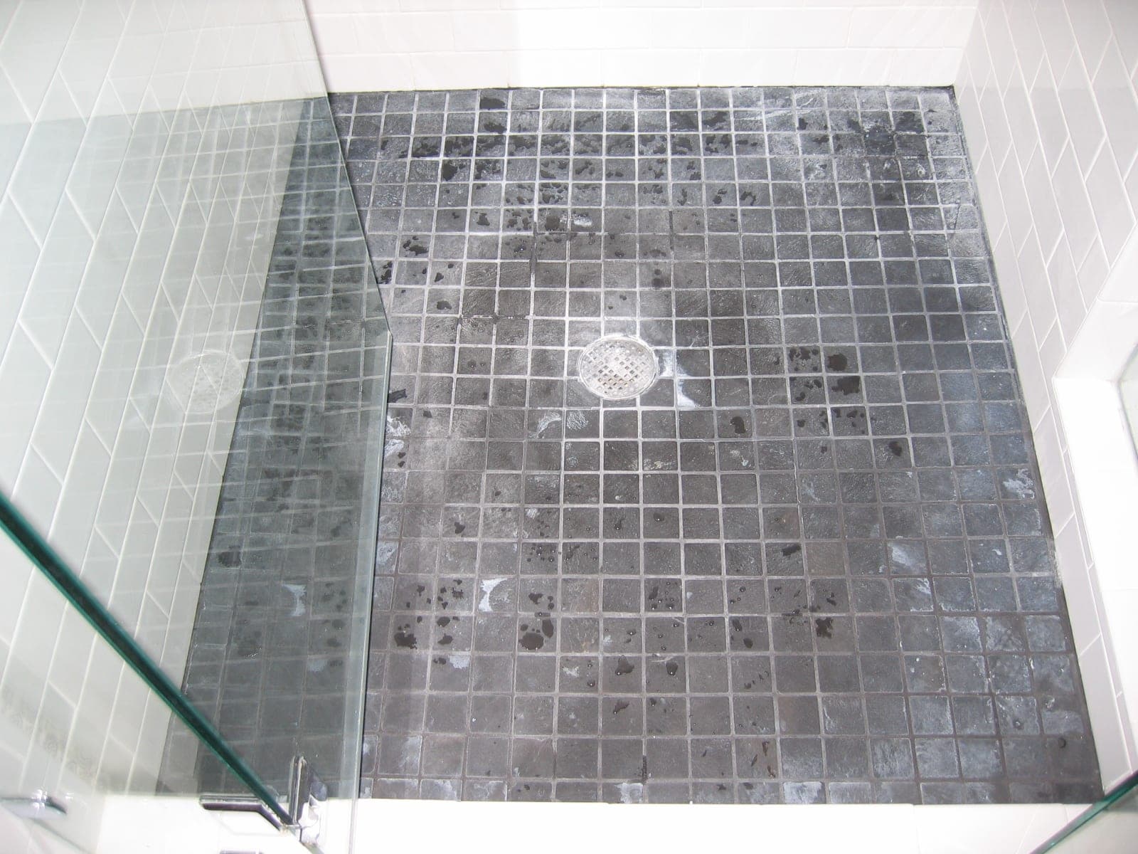 Before: Shower floor, soap scum and scale stripped